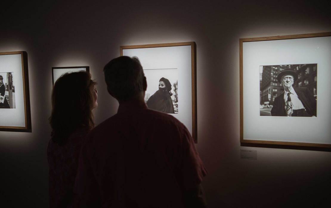 Visitors receive photographs exhibited at Fotografiska's Vivian Maier Unseen Work in New York.